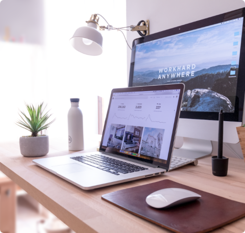 A desk with a dual monitor setup.